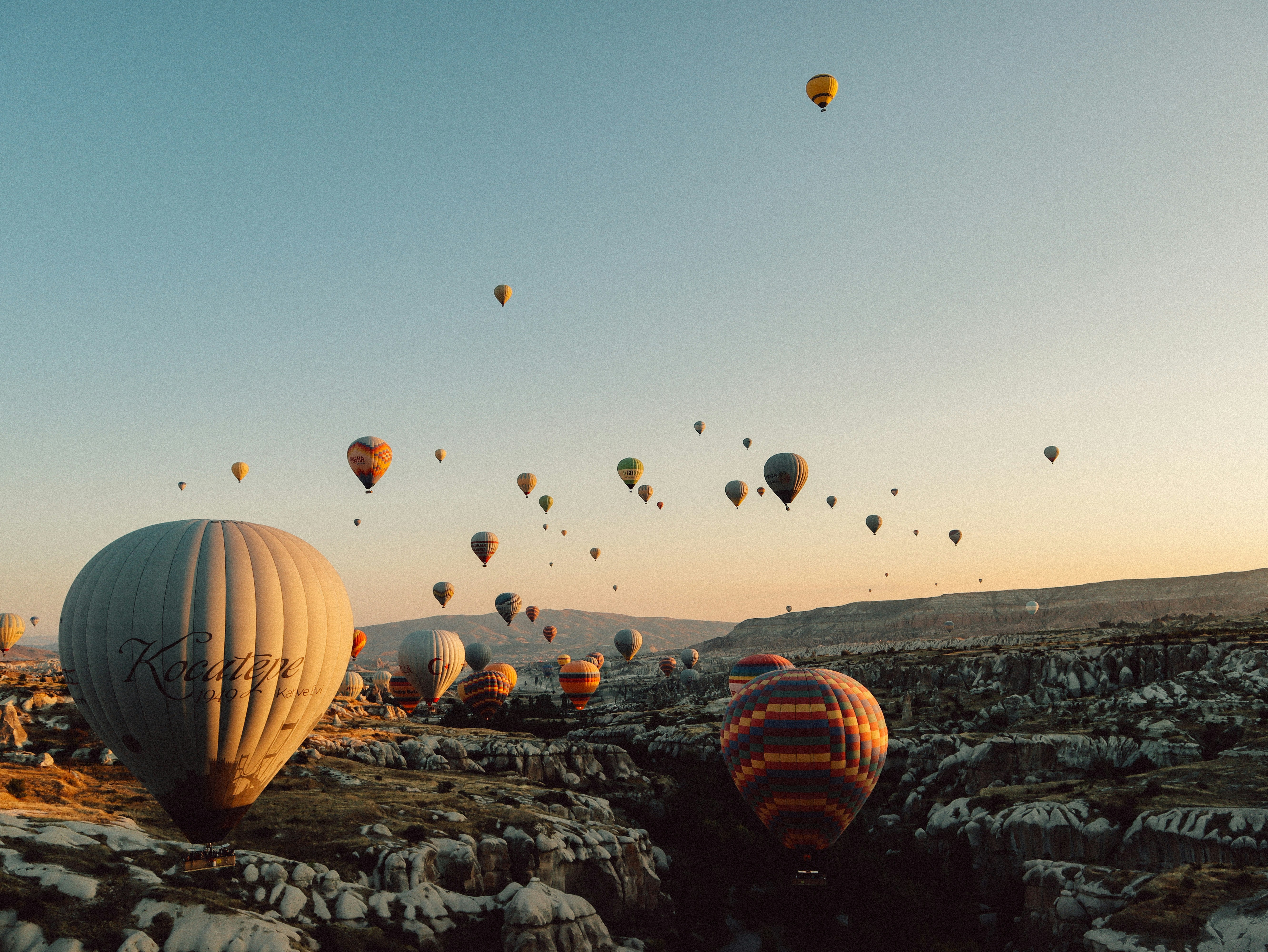 hot air balloons flying over the field during daytime, Kapadokya 