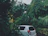 A private vehicle parked by a tropical roadside with lush greenery in Costa Rica.