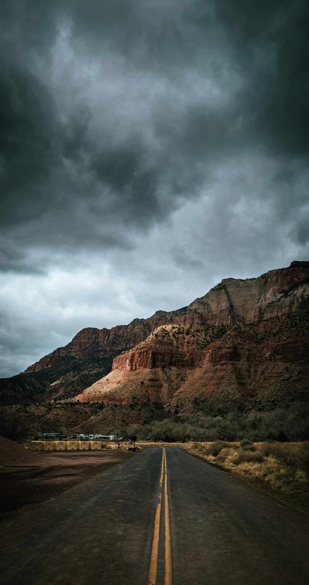 brown rocky mountain under cloudy sky during daytime