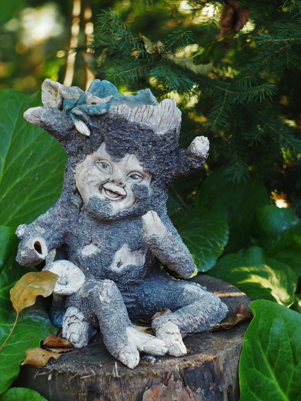 gray concrete lion statue on green leaves