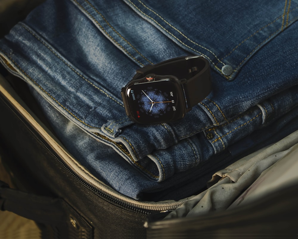 black leather belt on blue denim jeans