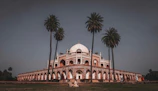 The serene gardens surrounding the Mausoleum of Mohammed V with intricate architecture.