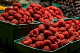 red strawberries in blue plastic container