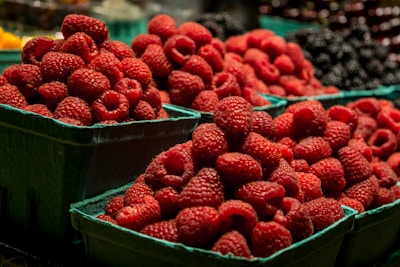 red strawberries in blue plastic container