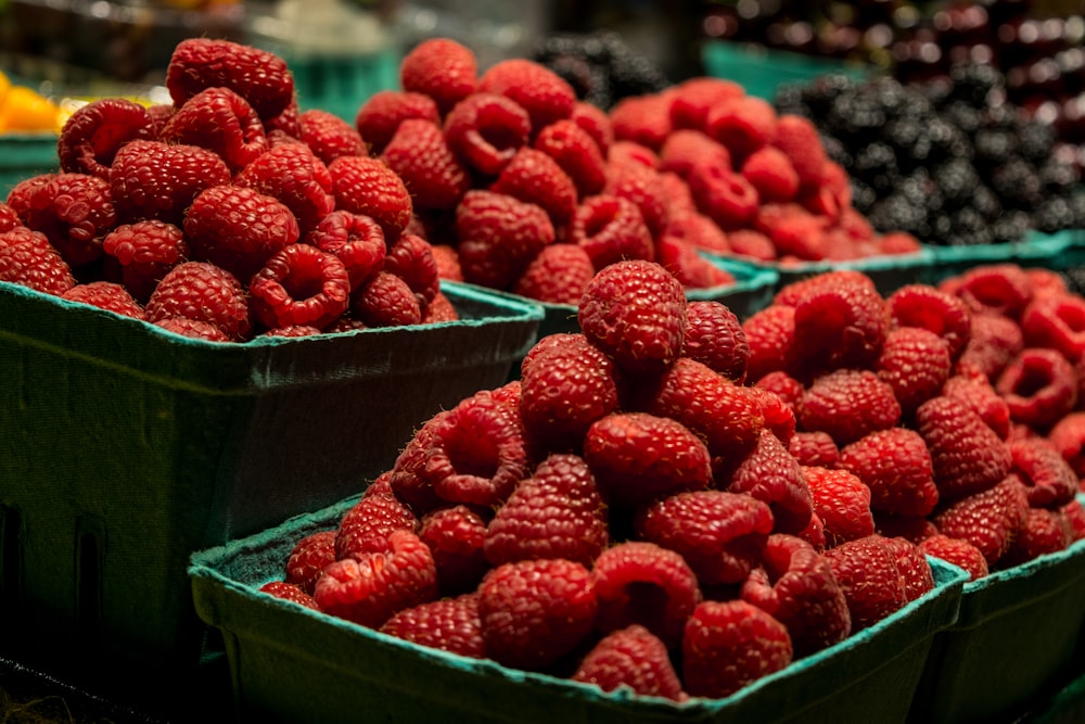 red strawberries in blue plastic container