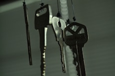black and silver keys on white wooden table