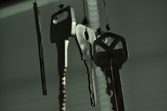 black and silver keys on white wooden table