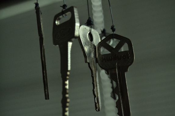black and silver keys on white wooden table