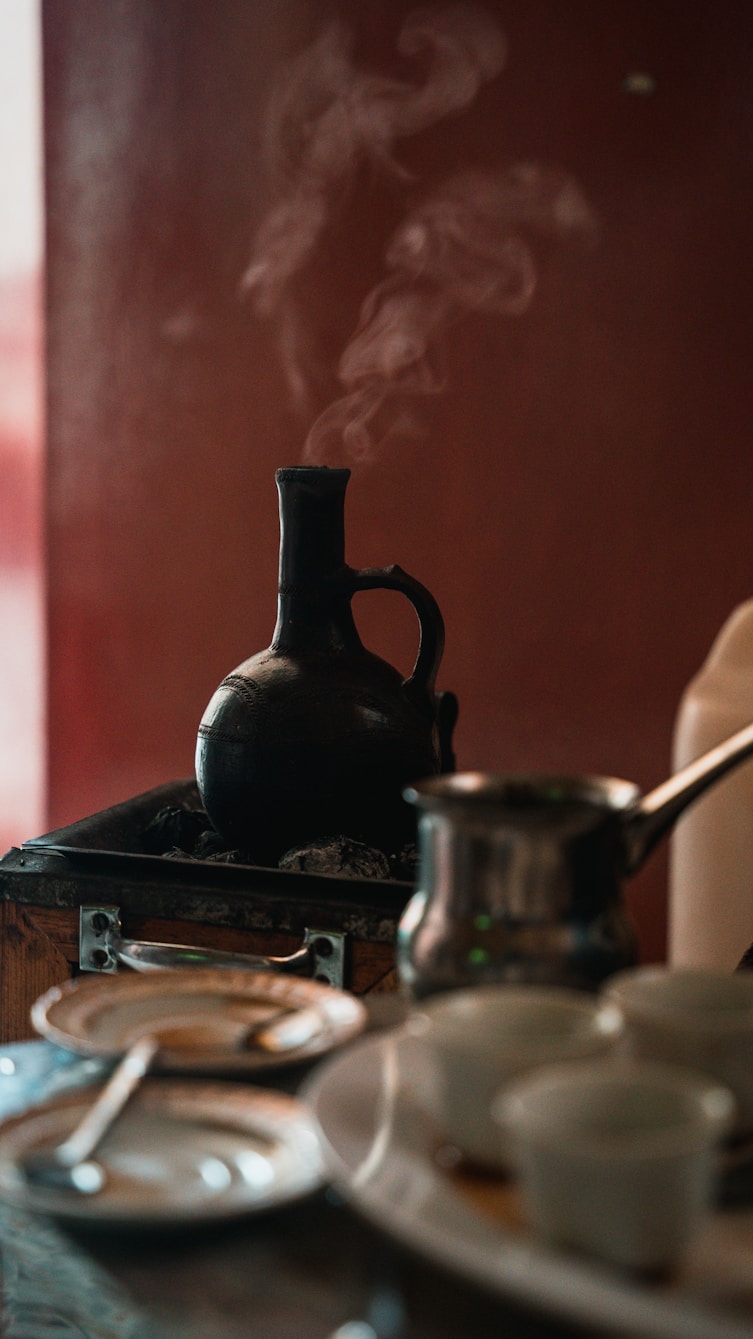 black kettle on stove with stainless steel pot