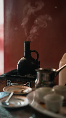 black kettle on stove with stainless steel pot