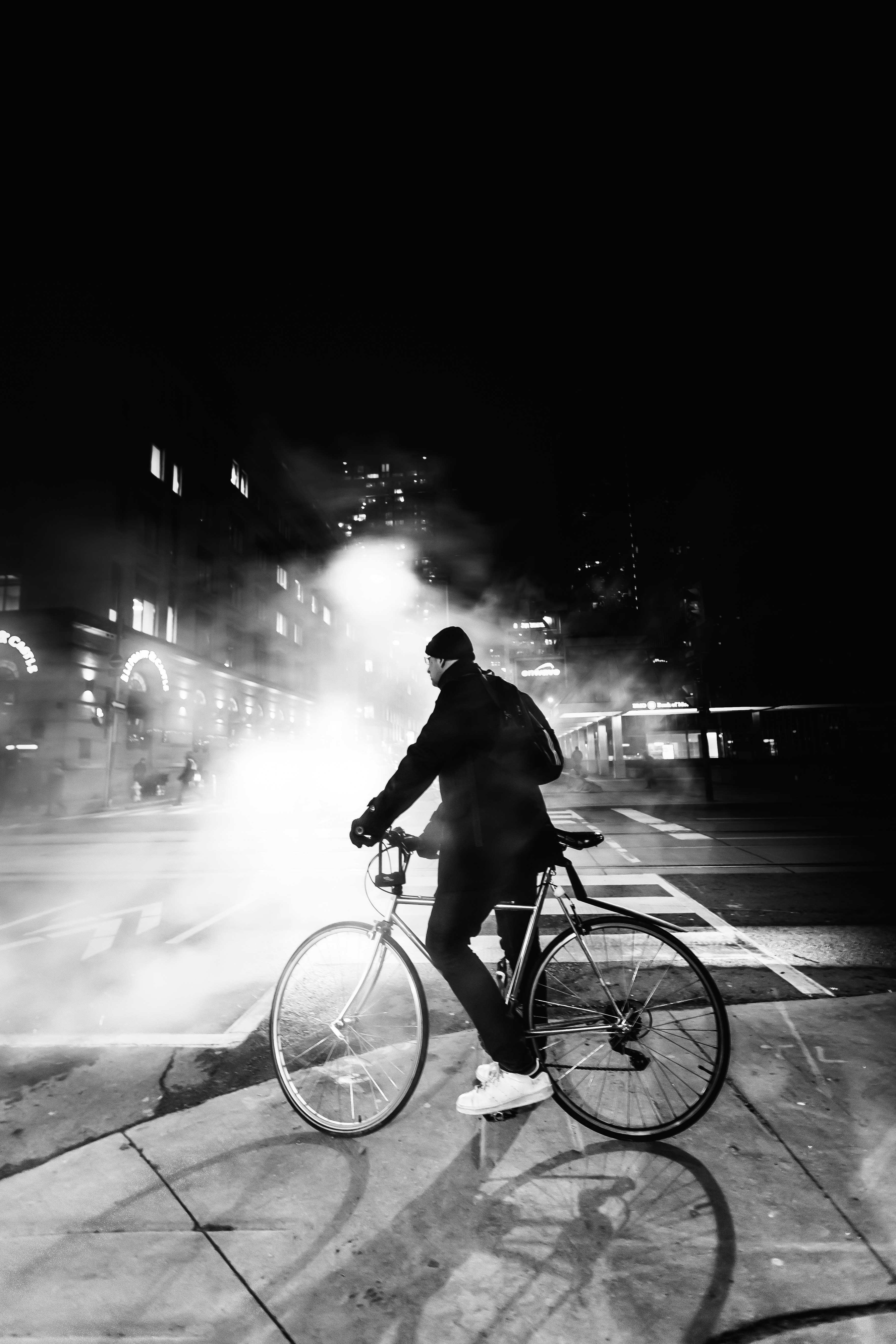 man riding bicycle on road during night time