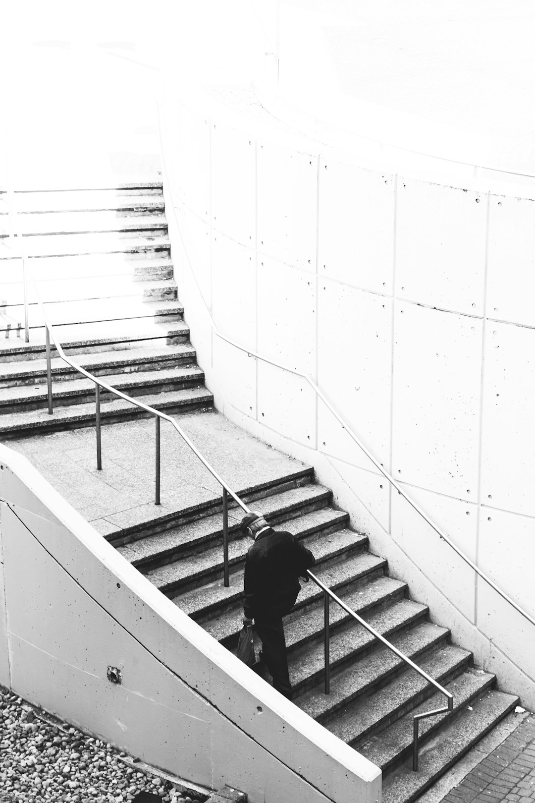 person in black jacket walking down the stairs