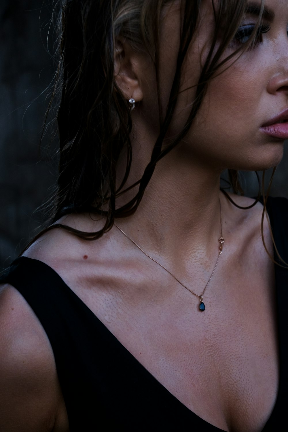 woman in black tank top wearing silver necklace