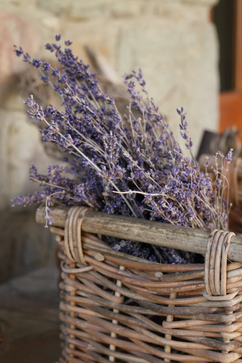 purple flowers in brown woven basket