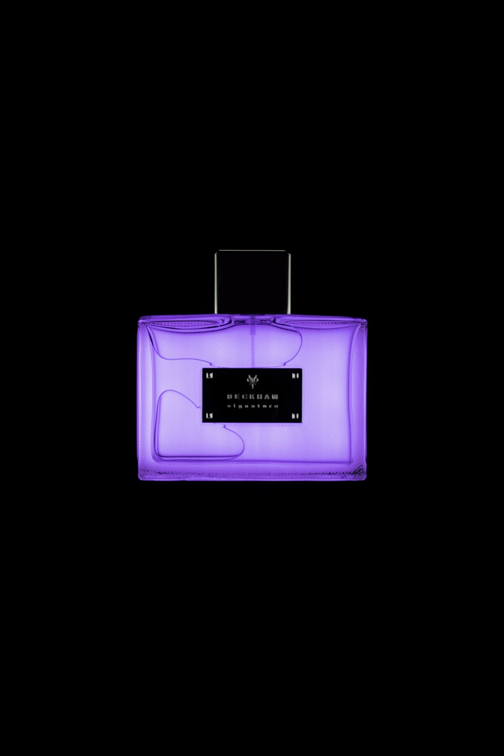 purple and white perfume bottle