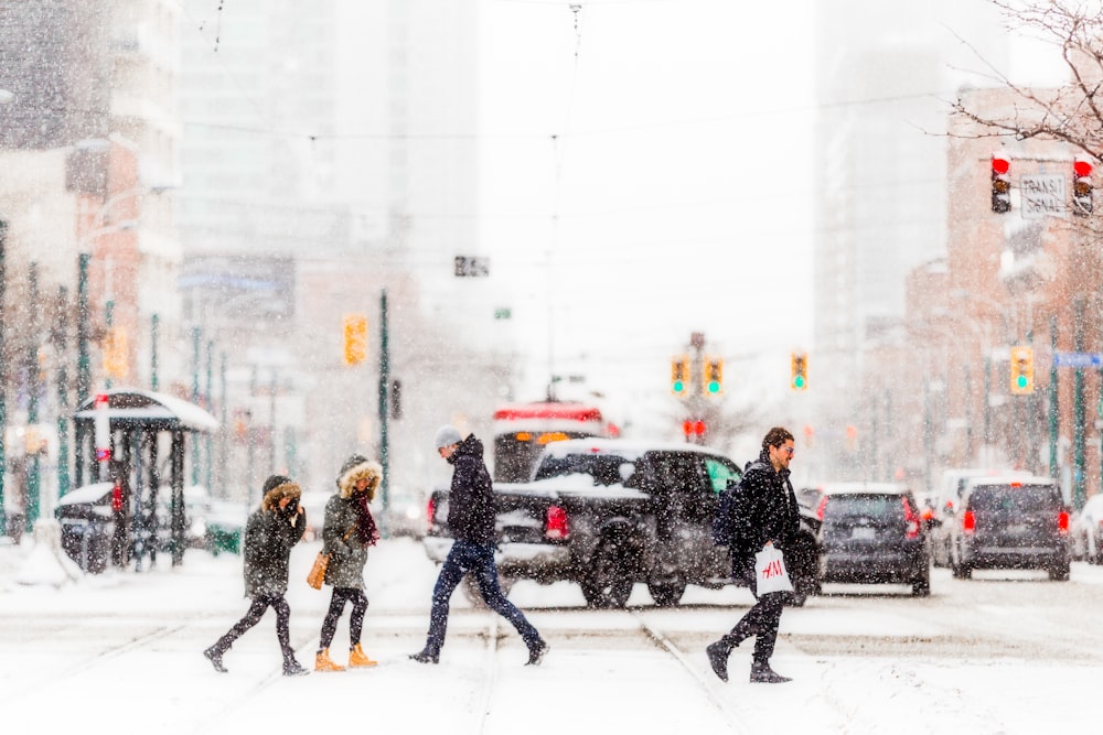 people walking on snow covered road during daytime