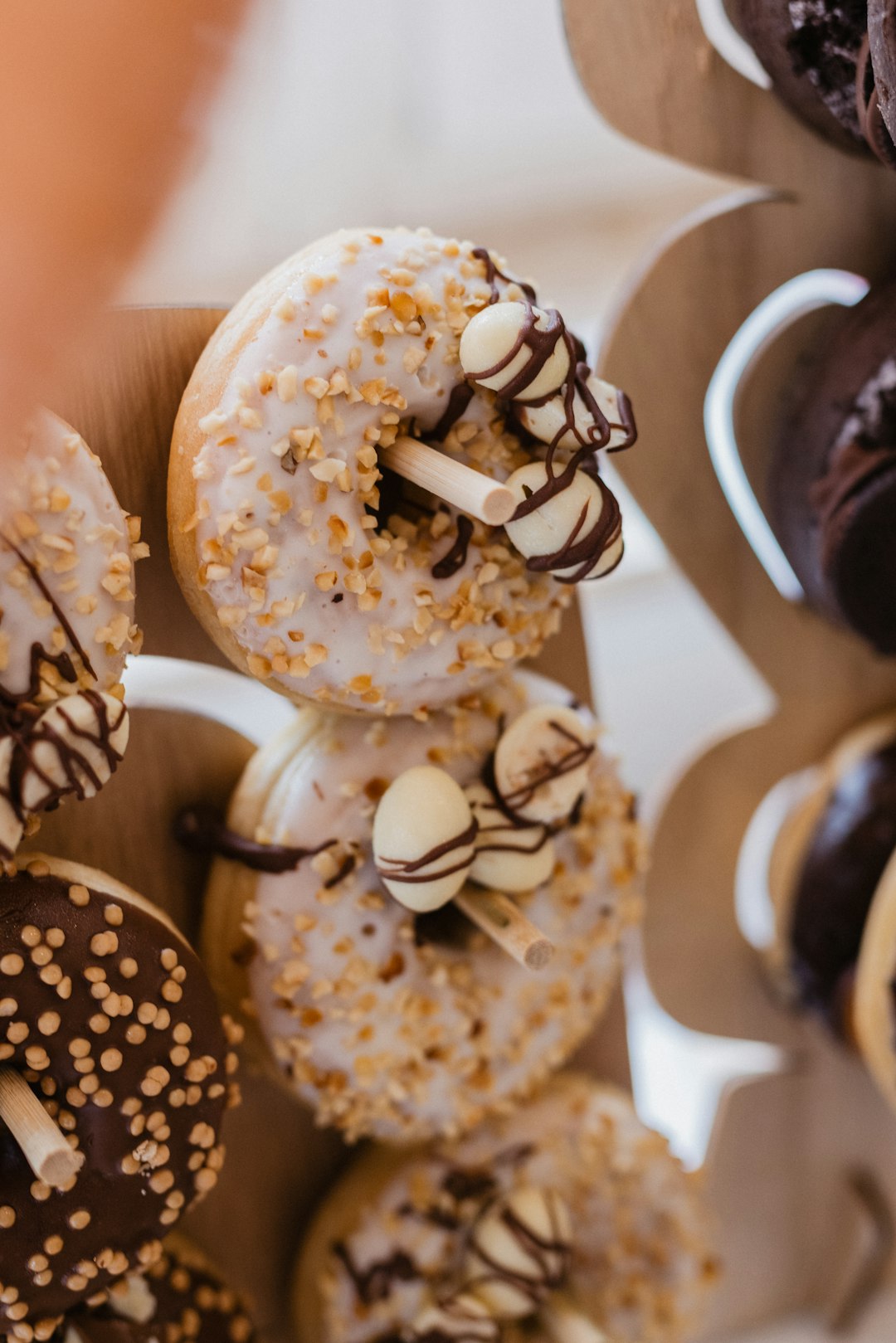 brown and white donut with white icing on top