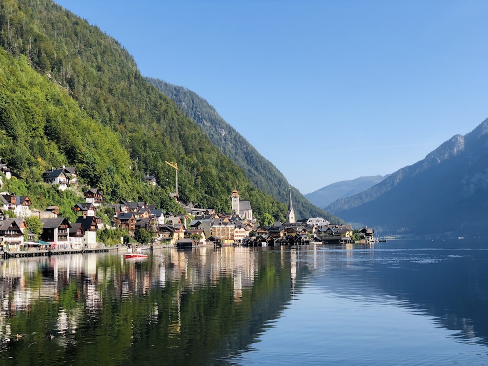 green mountain beside body of water during daytime