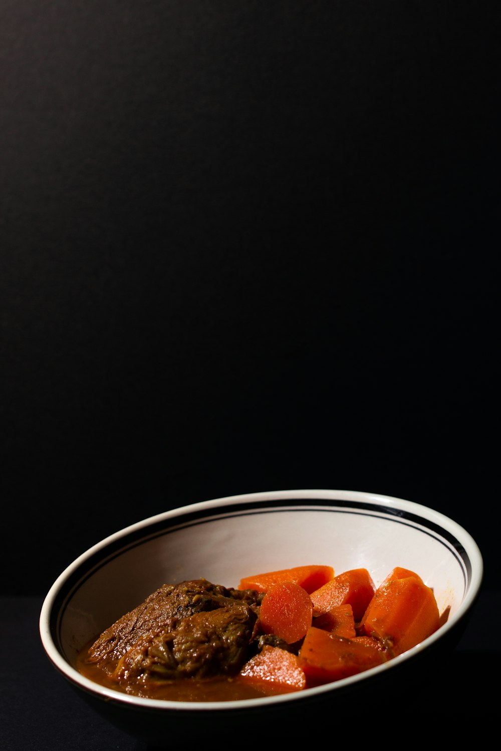 sliced carrots in white ceramic bowl