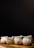 Several neatly arranged white dumplings rest on a wooden surface against a dark background. Their pleated shapes give them an appealing, handcrafted appearance.