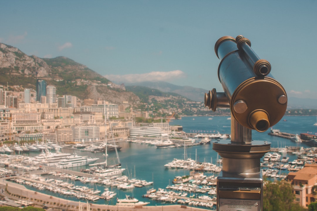 brown and black telescope across city buildings during daytime