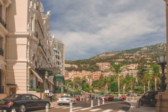 cars parked on side of road near buildings during daytime