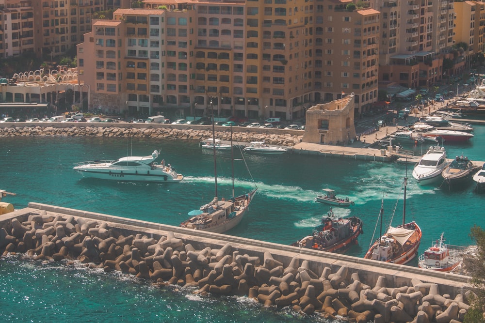 people on boat on sea near buildings during daytime