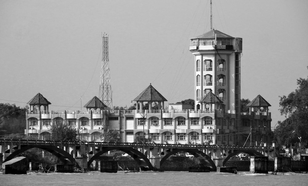 grayscale photo of building near body of water