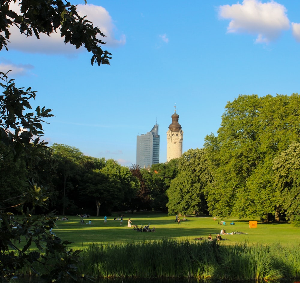 green grass field near trees and building during daytime