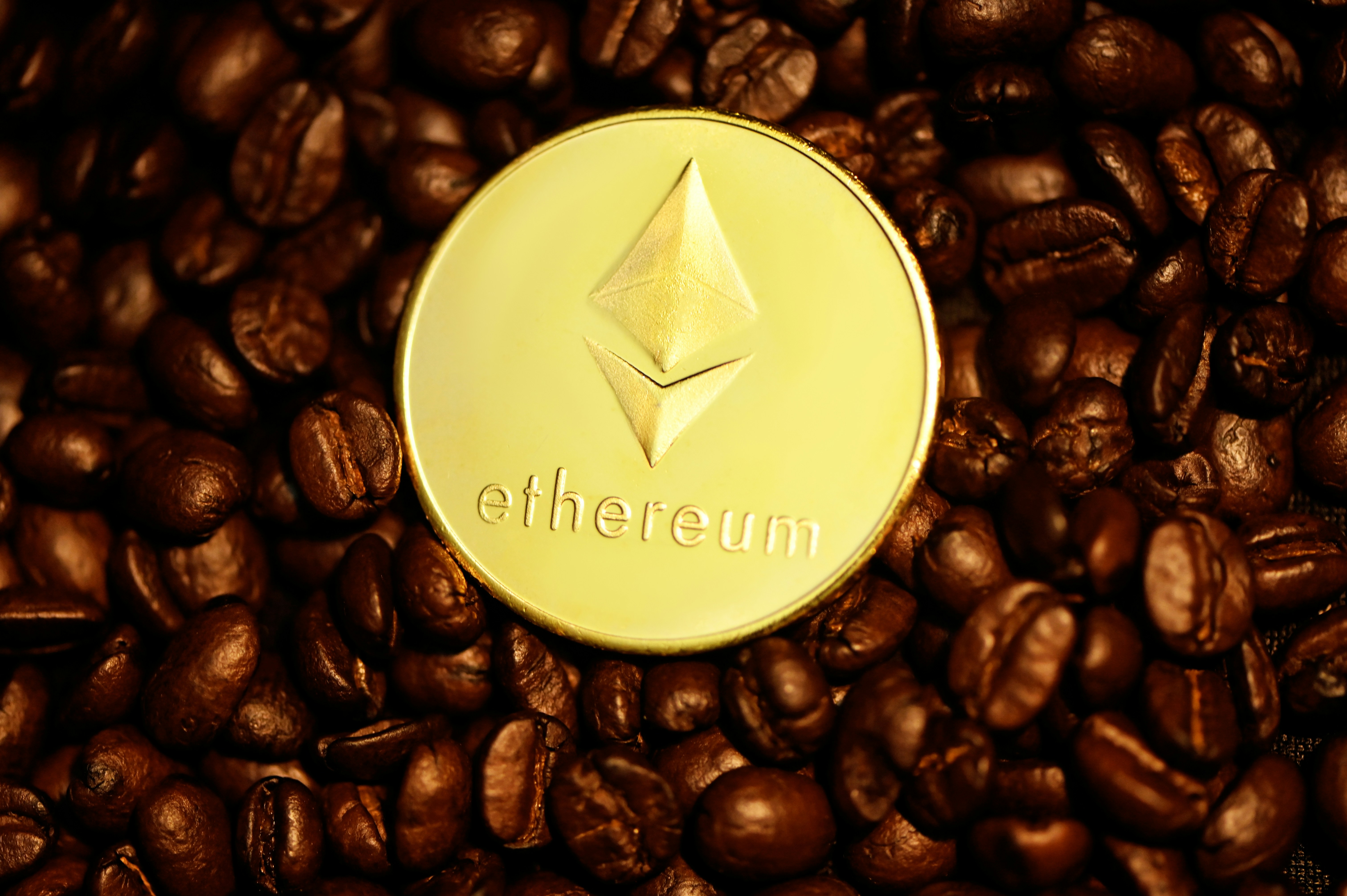 Ethereum coin on top of coffee beans