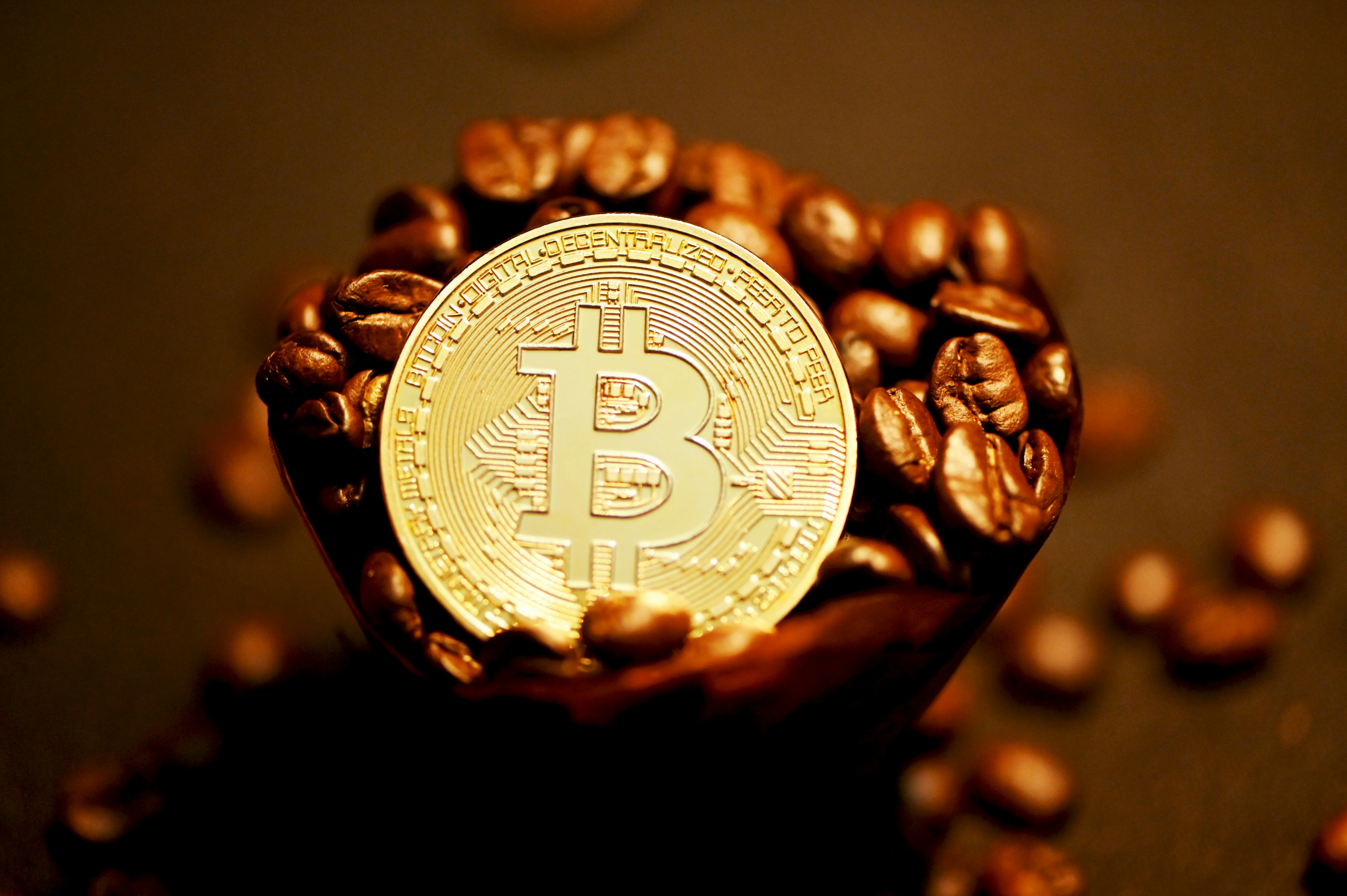 gold round coin on brown coffee beans