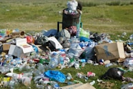 garbage on green grass field during daytime