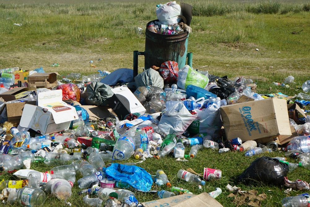 garbage on green grass field during daytime