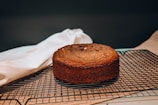 A warm kitchen scene showing a freshly baked brown sugar cake cooling on a rack.