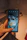 Close-up of a hand holding a phone scanning a medicine bottle with the Whealth app.