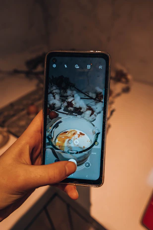 Dynamic shot of the bottle and phone in landscape mode, showing the 90° hinge feature in action during a FaceTime call.