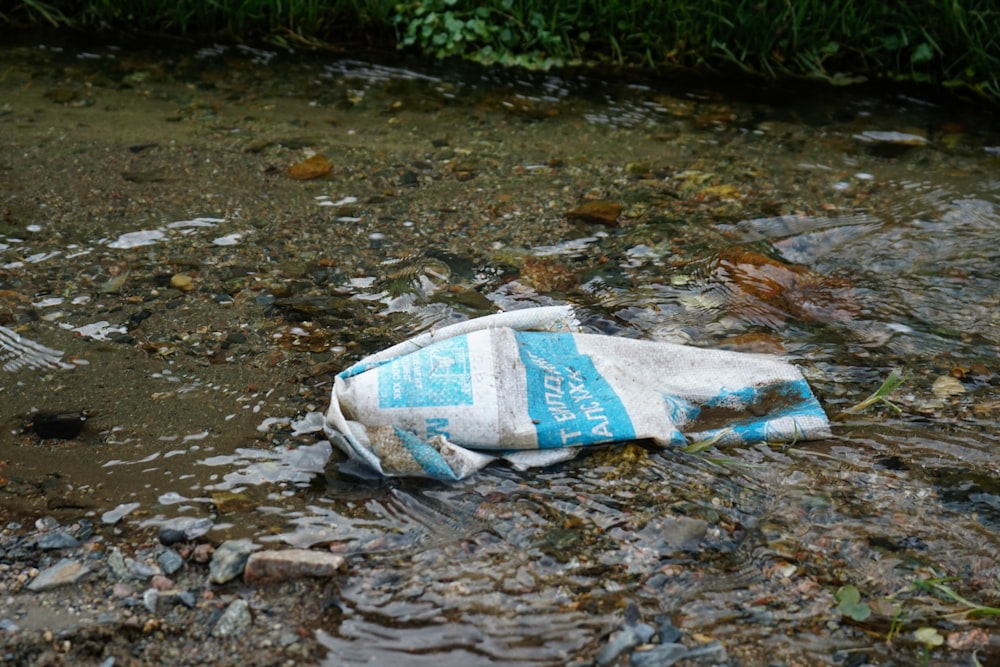 white and blue plastic bags on ground