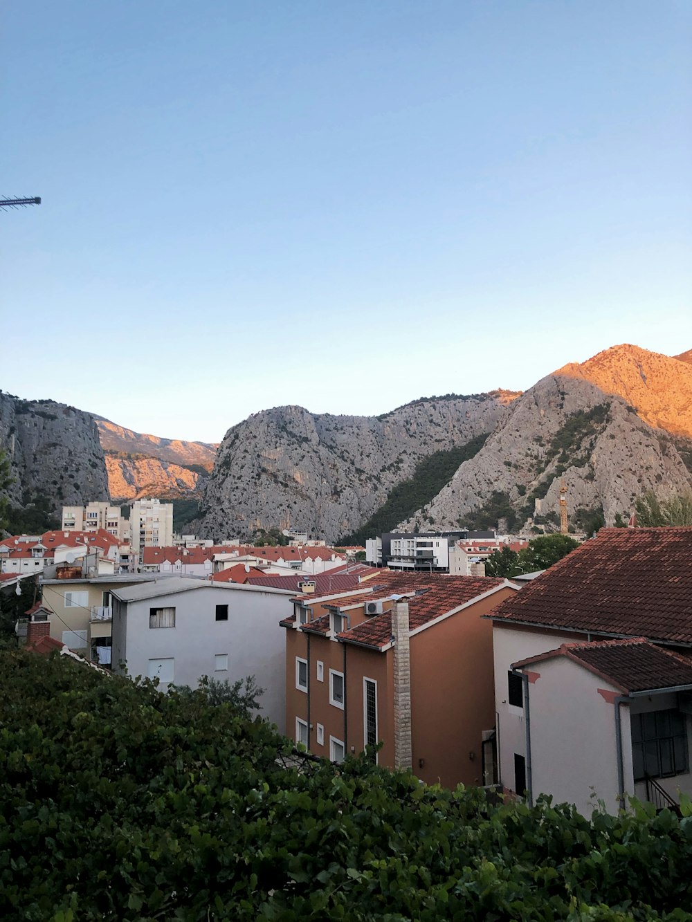 white and brown concrete houses near mountain during daytime