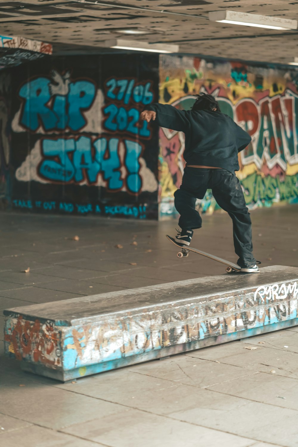 man in black jacket and black pants playing skateboard