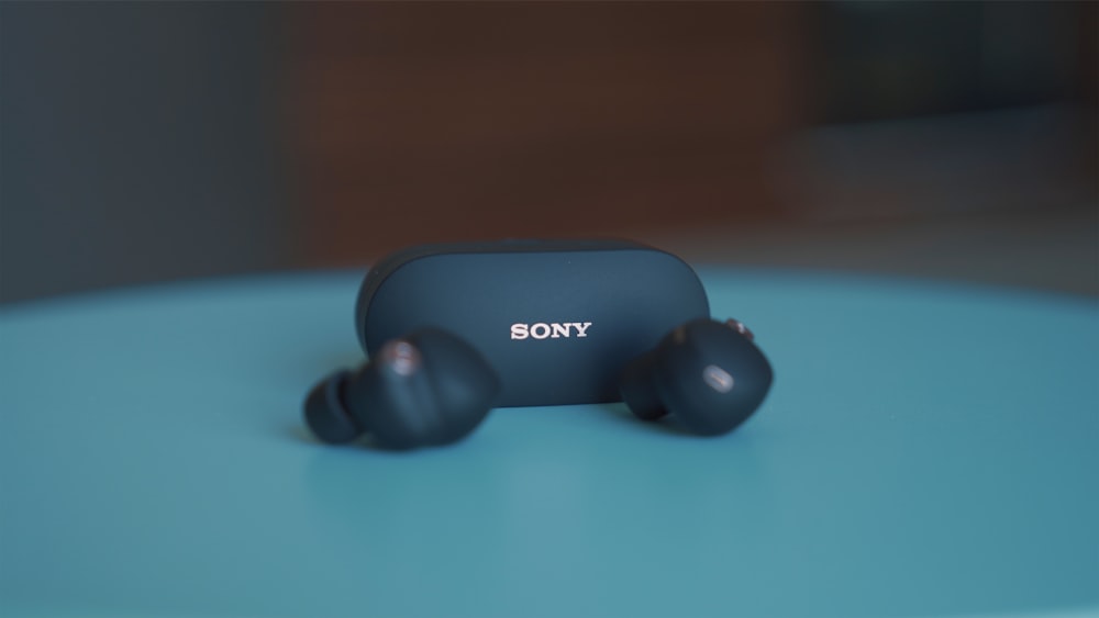 black sony headphones on blue table