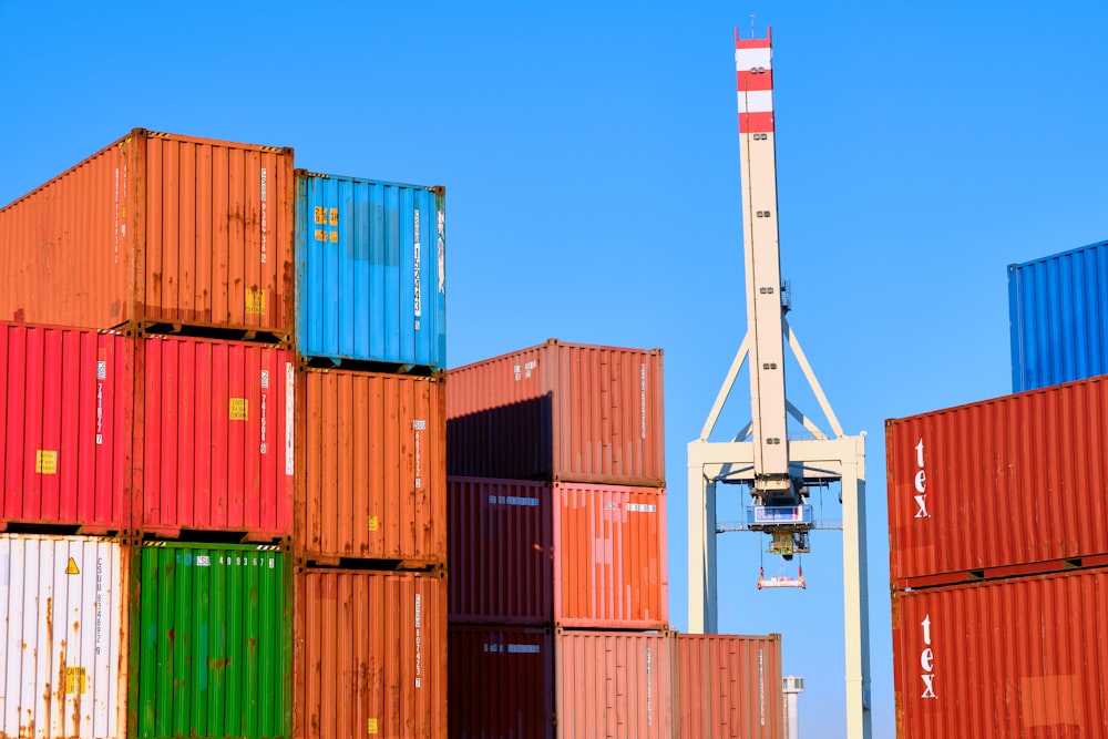 stack of cargo containers with white crane