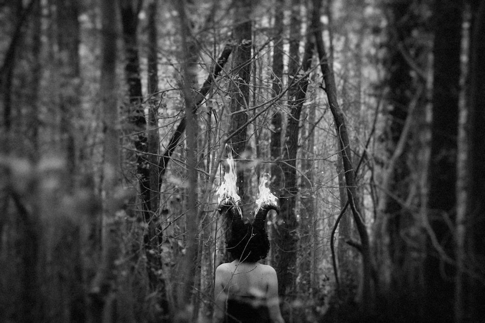 grayscale photo of woman in forest