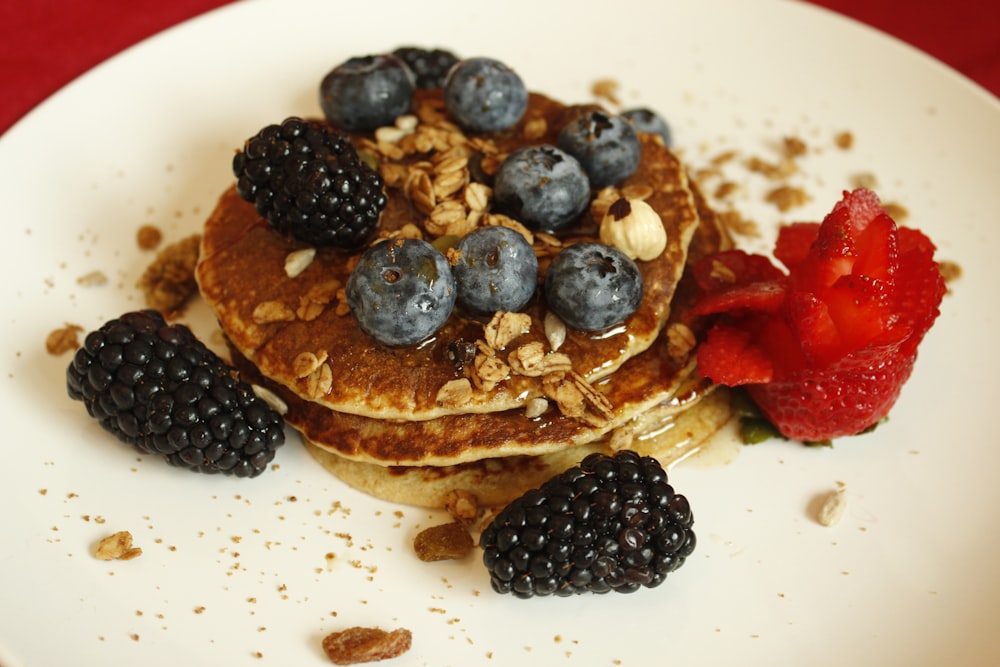 black berries on white ceramic plate