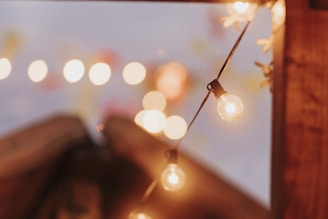 Close-up of rptmyst string lights hanging delicately, casting a gentle, warm ambiance.