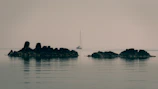 Sailboat on body of water reminding Leon Alderman of time in the Navy
