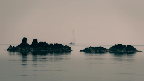 Sailboat on body of water reminding Leon Alderman of time in the Navy