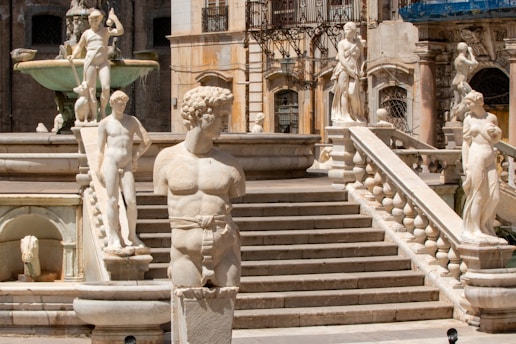 white concrete statue of man and woman