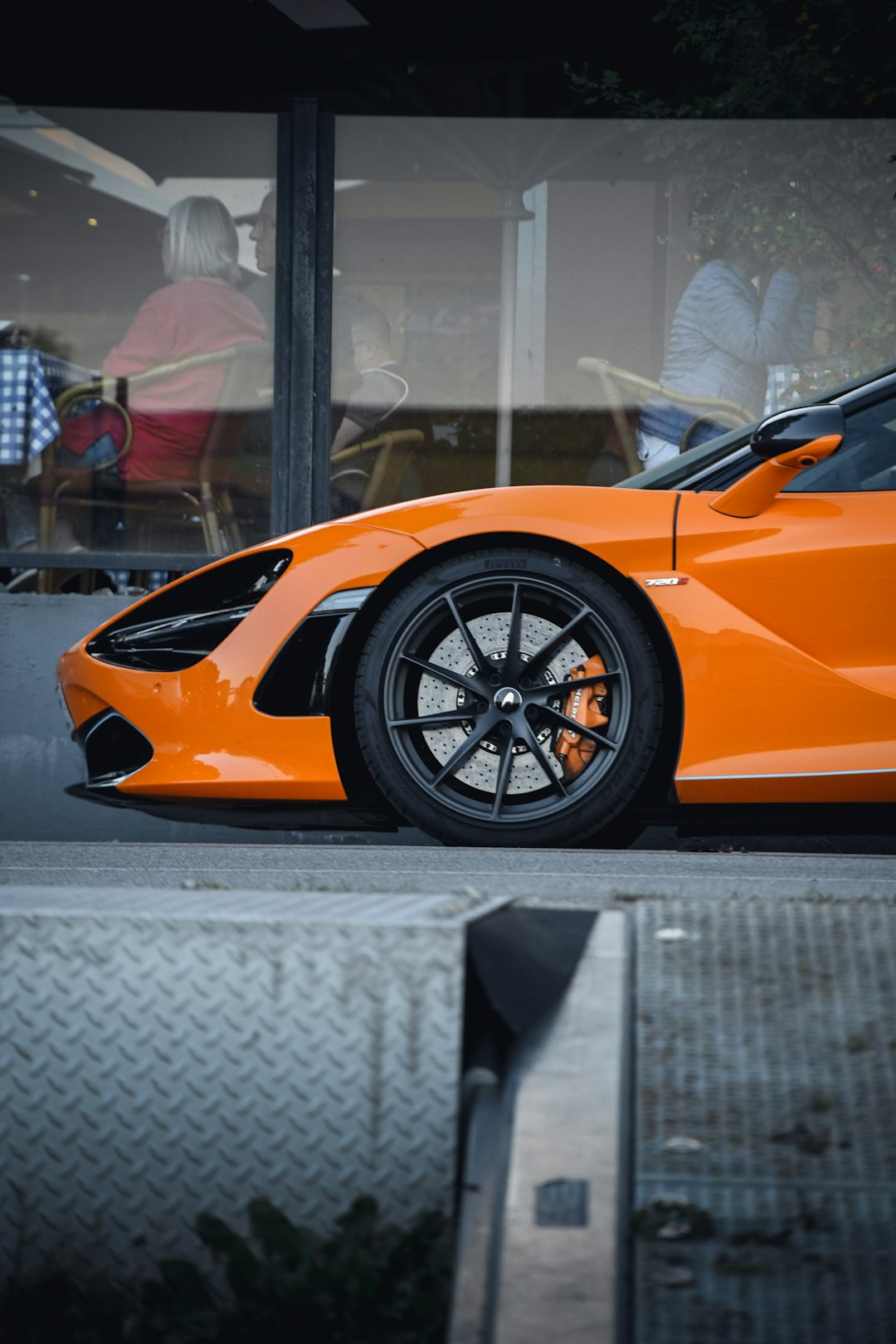 orange ferrari 458 italia parked on gray concrete floor