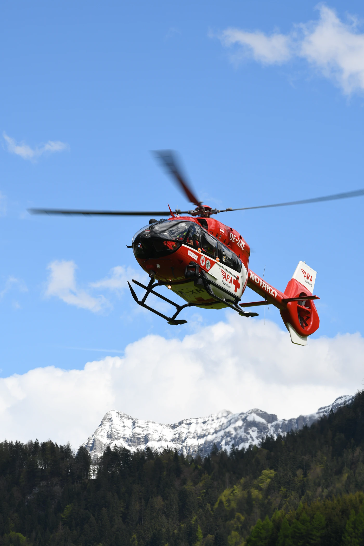 Helicopter over snowy mountains