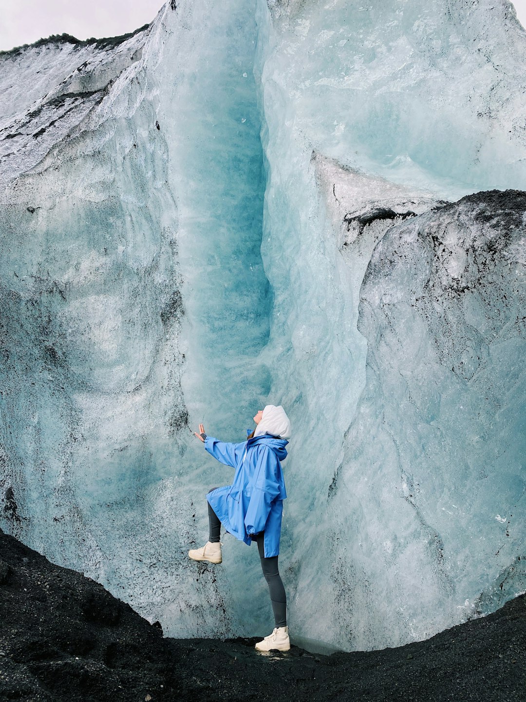 boy in blue and orange hoodie and blue denim jeans standing on rock